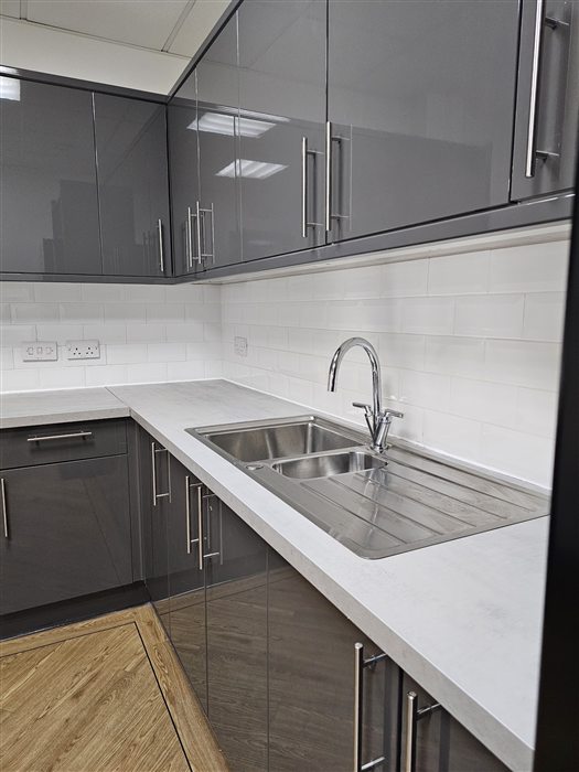 Grey gloss office kitchen with white worktops